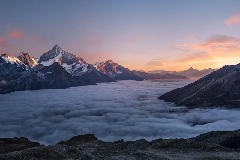 Sunrise over mountains above a misty valley